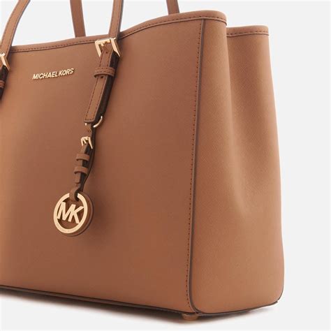 michael kors jet set logo large brown totes|Michael Kors bag with airplanes.